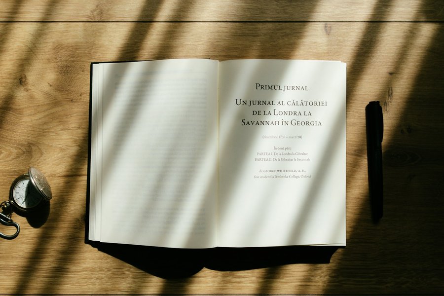 Photo from Unsplash (open book on a wooden table).